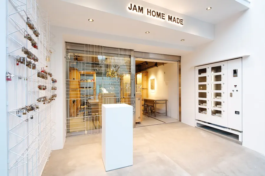 The store front of JAM HOME MADE, a jewelry store in Tokyo, with a vending machine