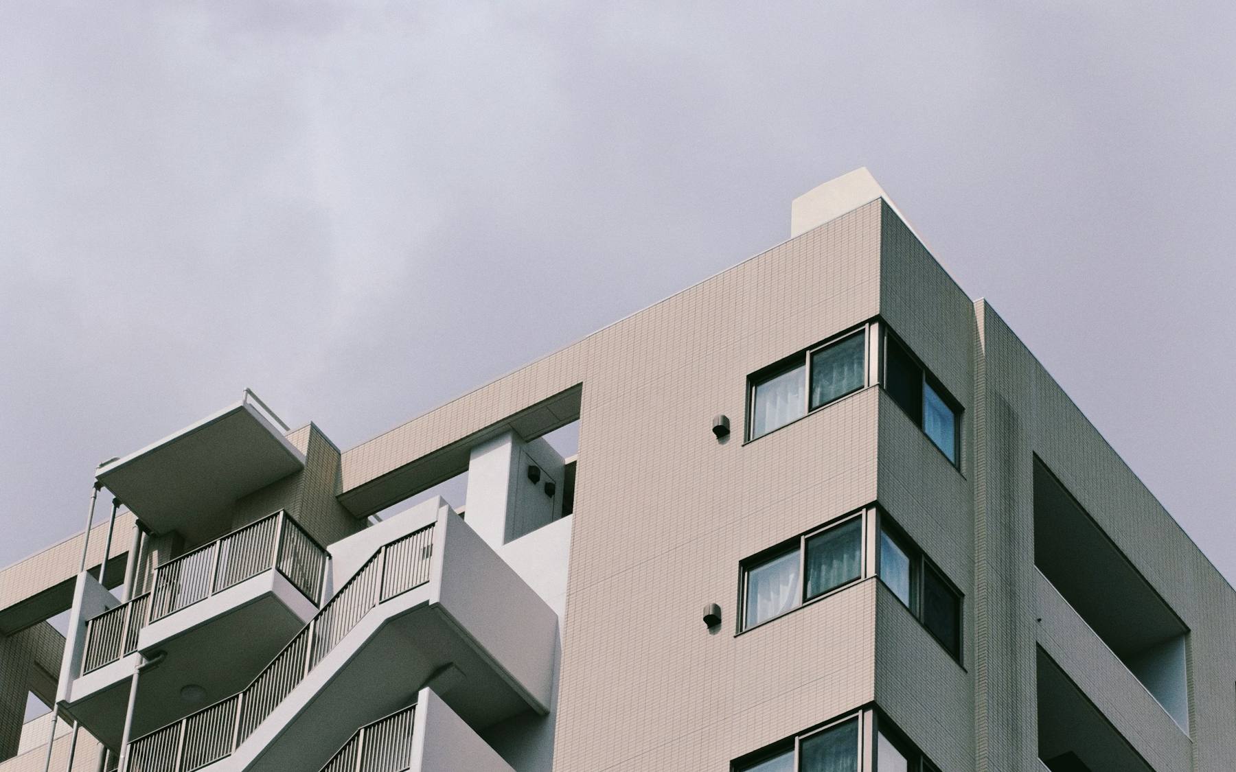 Modern apartment building exterior in Tokyo representing managed rental properties in Japan