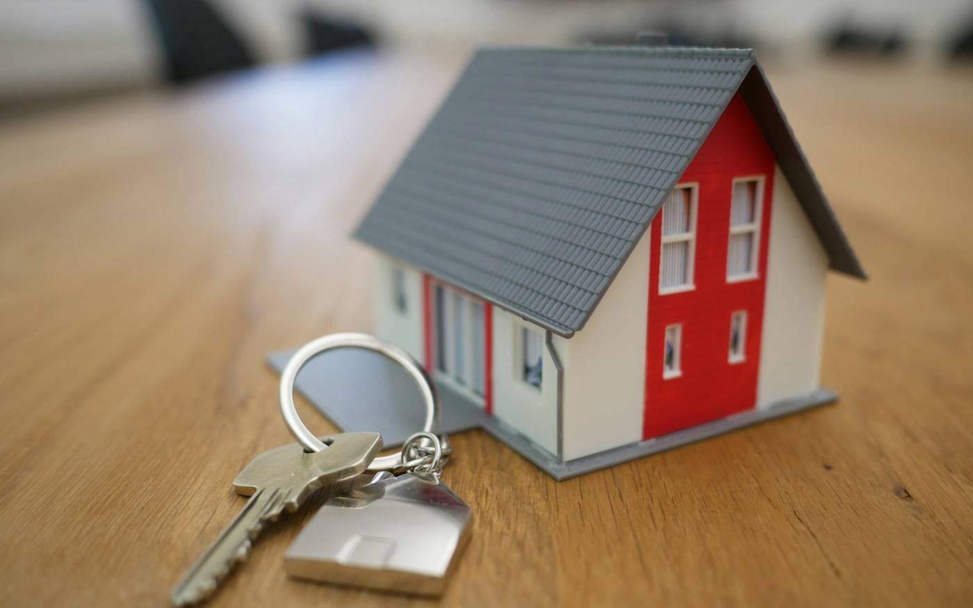 House keys and model home representing managed rental properties