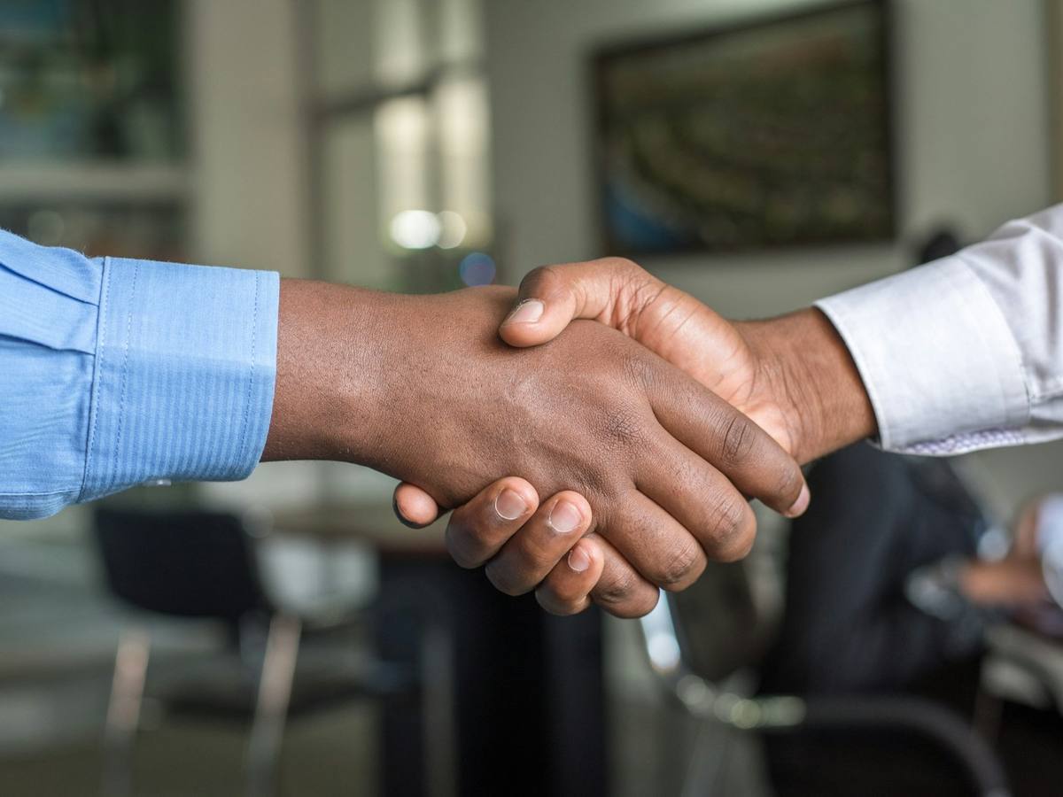 Business handshake representing a CallButler property management partnership
